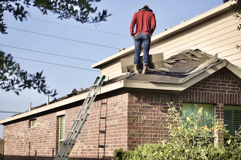Professional roofer working on a residential roof in Camp Echockotee